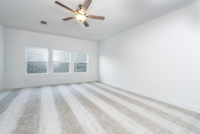 unfurnished room featuring light colored carpet and ceiling fan