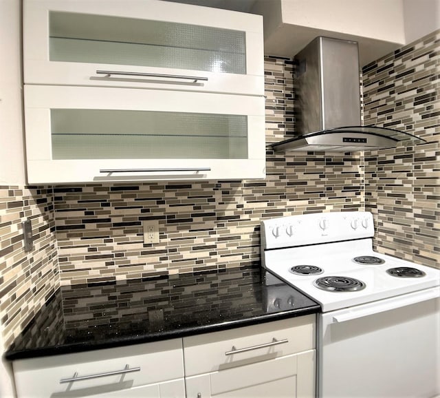 kitchen featuring white cabinets, wall chimney exhaust hood, backsplash, and white electric stove