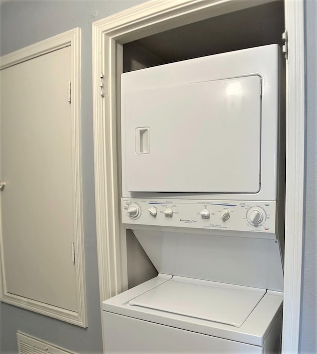 washroom with stacked washer / drying machine