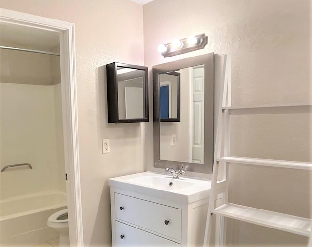 full bathroom with tile patterned flooring, vanity,  shower combination, and toilet