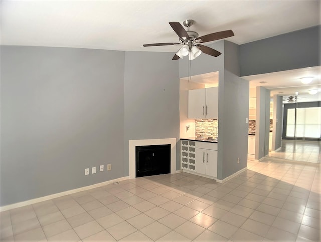 unfurnished living room with ceiling fan and light tile patterned flooring