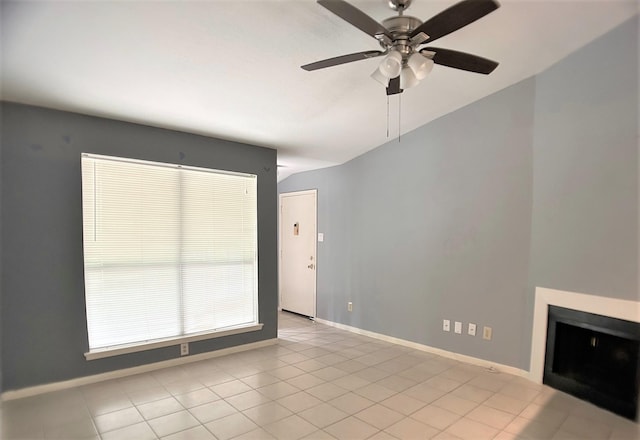 empty room with light tile patterned floors and ceiling fan