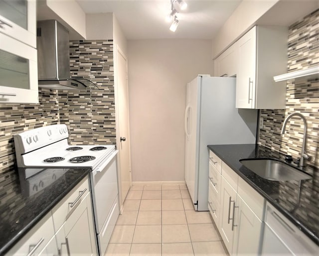 kitchen with sink, wall chimney range hood, light tile patterned flooring, white range with electric stovetop, and white cabinets