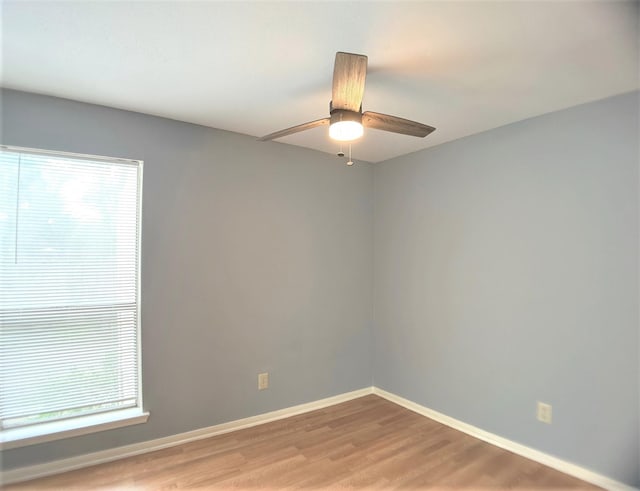 unfurnished room featuring plenty of natural light, light hardwood / wood-style floors, and ceiling fan