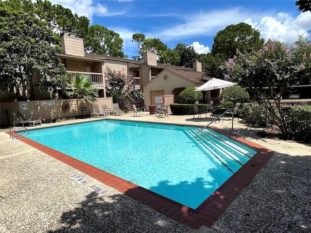 view of swimming pool with a patio area