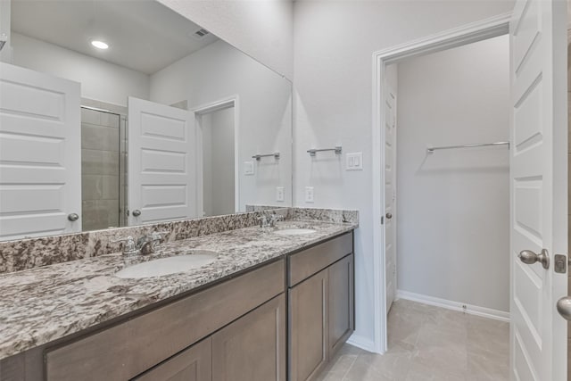 bathroom featuring vanity and a shower with shower door