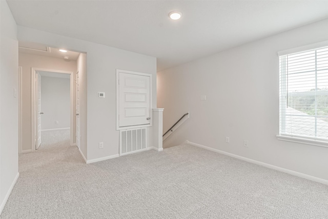 carpeted spare room with a healthy amount of sunlight