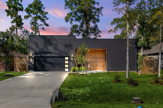 contemporary home with a lawn and a garage