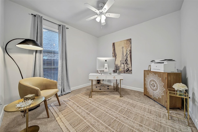 carpeted home office featuring ceiling fan