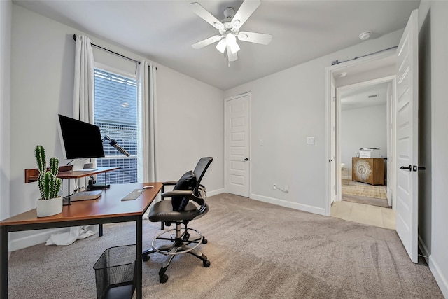 home office with ceiling fan and light colored carpet