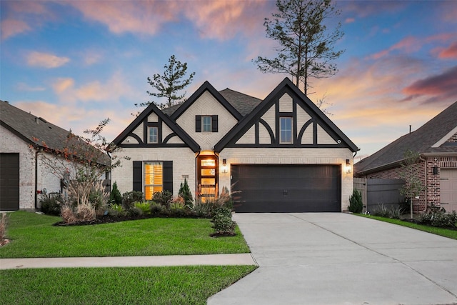 tudor house with a yard and a garage