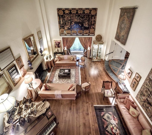 interior space with a towering ceiling and hardwood / wood-style flooring