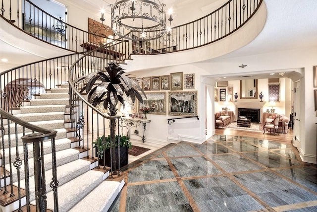 staircase with a chandelier and a high ceiling