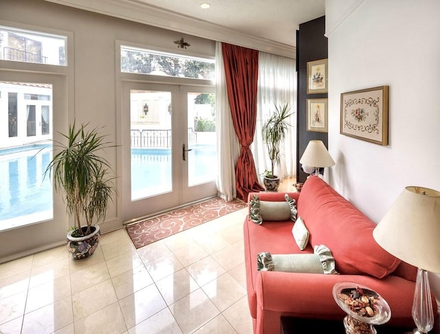 entryway with light tile patterned floors, crown molding, and french doors