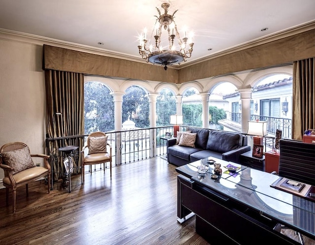 living room with crown molding, dark wood-type flooring, and an inviting chandelier