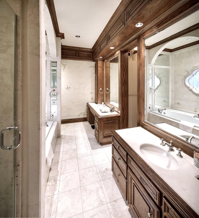 bathroom featuring plus walk in shower, vanity, ornamental molding, and tile patterned flooring