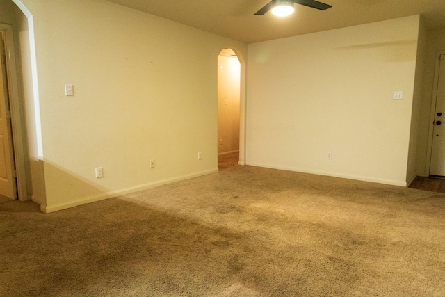 carpeted spare room with ceiling fan