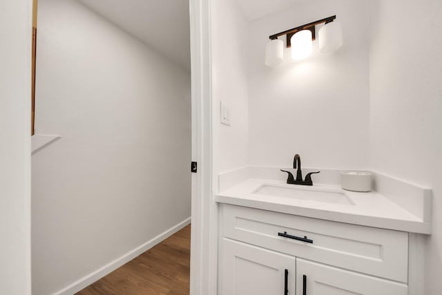 bathroom with vanity and hardwood / wood-style flooring