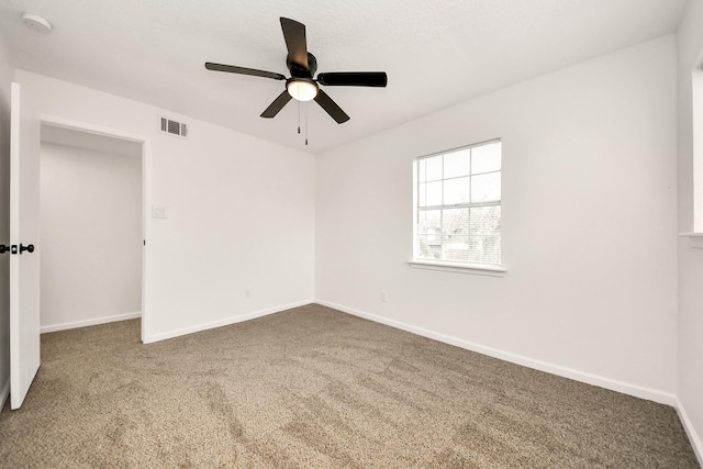 carpeted empty room featuring ceiling fan