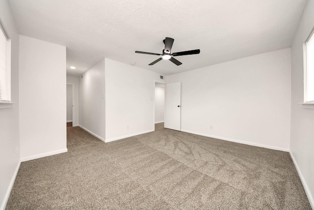 empty room with carpet floors and ceiling fan