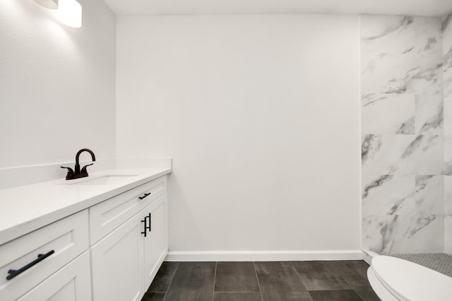 bathroom featuring vanity, toilet, and walk in shower