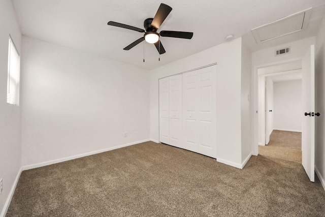 unfurnished bedroom with ceiling fan, a closet, and dark colored carpet