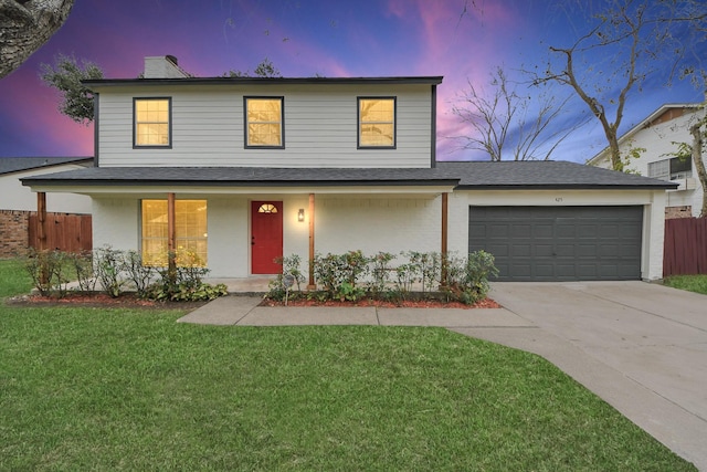 front facade featuring a lawn, a porch, and a garage