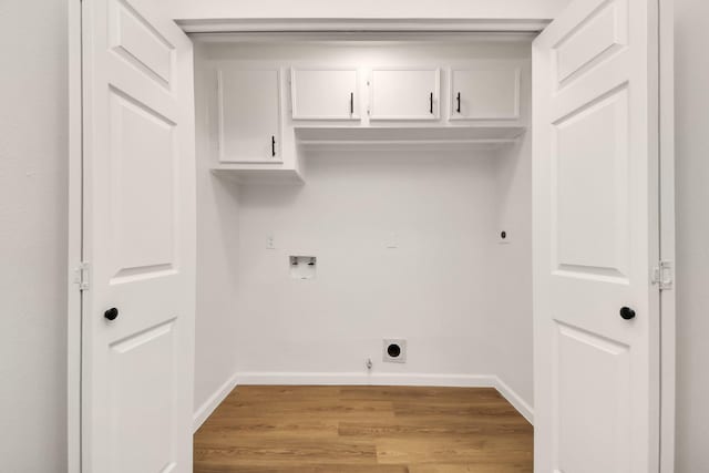 washroom featuring electric dryer hookup, cabinets, gas dryer hookup, hookup for a washing machine, and light hardwood / wood-style floors