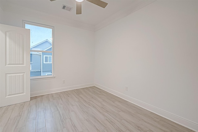 spare room featuring ornamental molding, ceiling fan, and light hardwood / wood-style floors