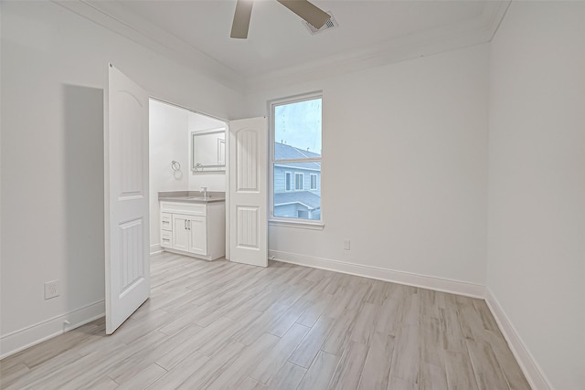 spare room with sink, light wood-type flooring, ceiling fan, and crown molding