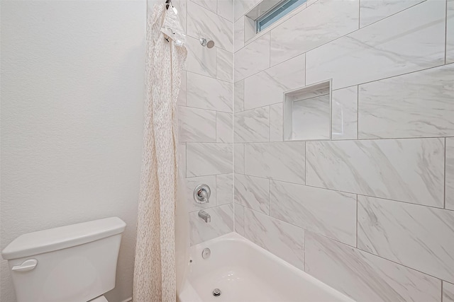 bathroom with toilet and tiled shower / bath combo