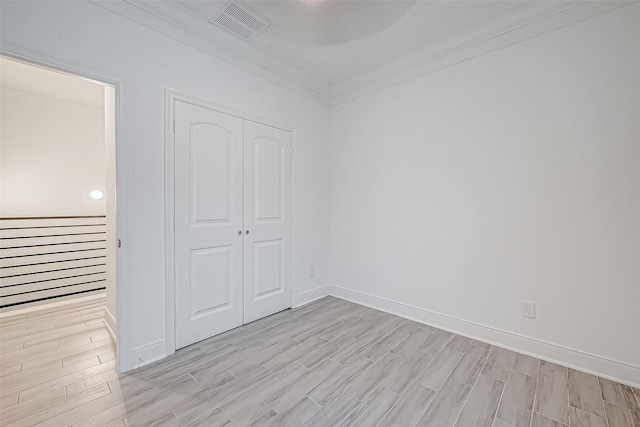 unfurnished bedroom featuring a closet and ornamental molding