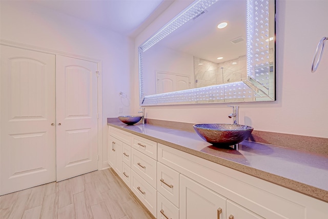 bathroom featuring an enclosed shower and vanity