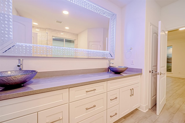 bathroom featuring wood-type flooring and vanity