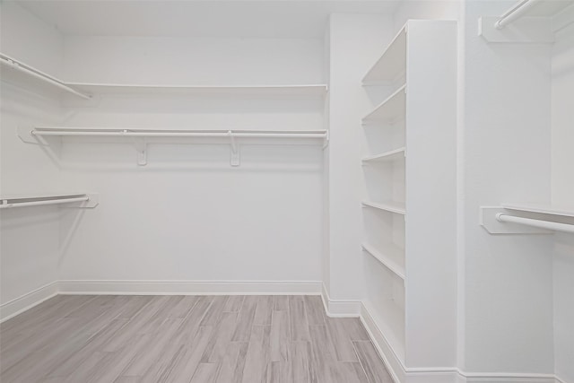 spacious closet with light hardwood / wood-style floors