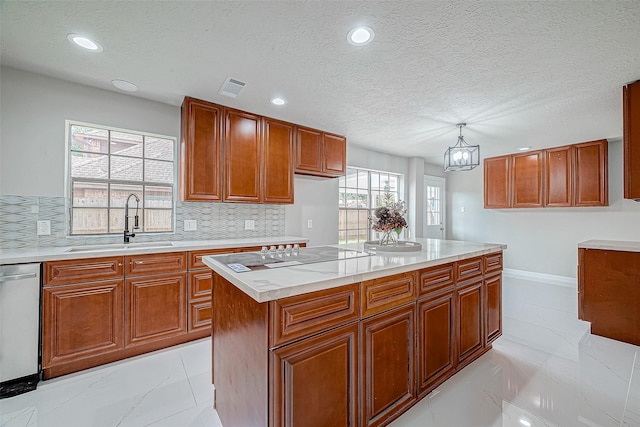 kitchen featuring dishwasher, sink, a center island, backsplash, and pendant lighting