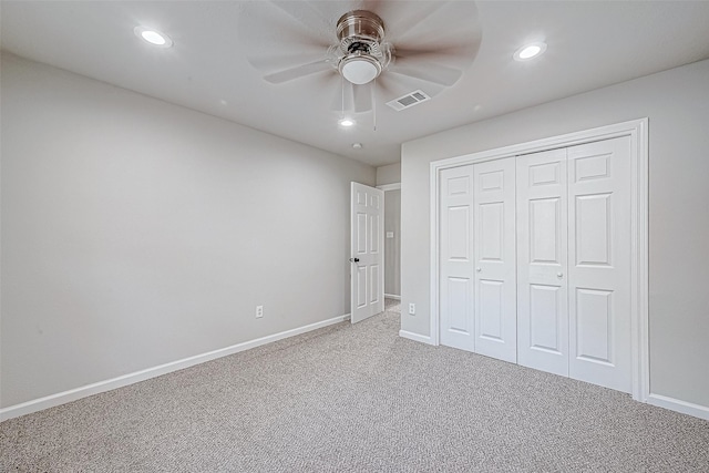 unfurnished bedroom featuring carpet, ceiling fan, and a closet