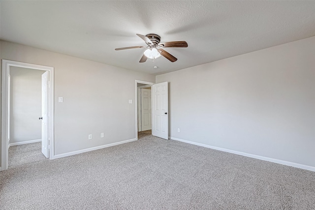 empty room with carpet, a textured ceiling, and ceiling fan