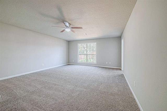 carpeted spare room with a textured ceiling and ceiling fan