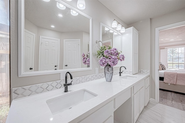 bathroom with vanity and a textured ceiling