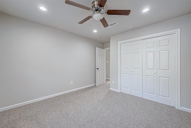 unfurnished bedroom with carpet flooring, a closet, and ceiling fan