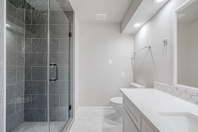 bathroom featuring vanity, toilet, and a shower with shower door