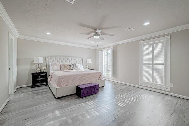 bedroom featuring a textured ceiling, ceiling fan, light hardwood / wood-style floors, and crown molding