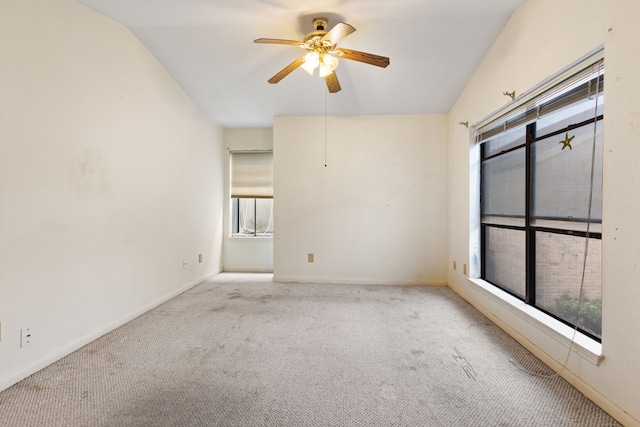 carpeted empty room with ceiling fan and lofted ceiling