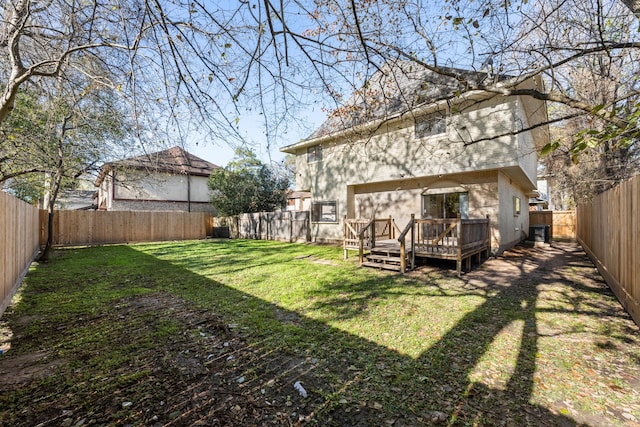 rear view of house with a yard and a wooden deck