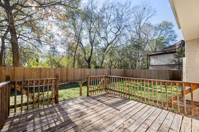 wooden deck featuring a lawn