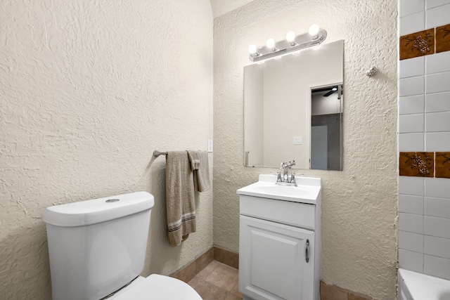 bathroom with a bathing tub, vanity, and toilet