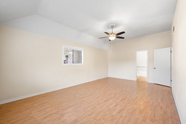 spare room featuring ceiling fan, lofted ceiling, and light hardwood / wood-style flooring