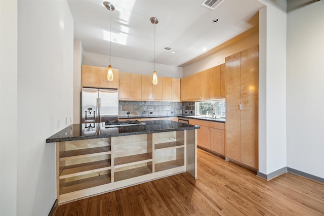 kitchen featuring kitchen peninsula, appliances with stainless steel finishes, hanging light fixtures, and light brown cabinetry