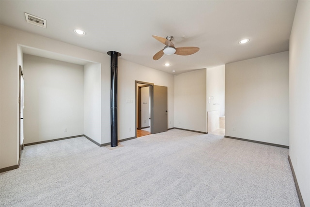 unfurnished bedroom with connected bathroom, light colored carpet, and ceiling fan